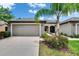 Charming single Gathering home with an attached two-car garage and verdant landscaping at 14047 Weddington Ter, Hudson, FL 34669