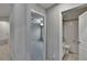 Hallway view featuring bedroom and bathroom; neutral tones, updated fixtures, and spacious layout at 14047 Weddington Ter, Hudson, FL 34669