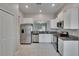 Bright kitchen with stainless steel appliances, granite countertops, and access to living area at 14047 Weddington Ter, Hudson, FL 34669