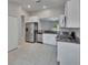 Kitchen with stainless steel appliances, granite countertops, and a view of the living area at 14047 Weddington Ter, Hudson, FL 34669