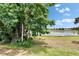 Scenic lake view from the lush green lawn, creating a peaceful and idyllic setting at 14047 Weddington Ter, Hudson, FL 34669