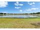 Expansive lake view surrounded by lush greenery and a clear blue sky at 14047 Weddington Ter, Hudson, FL 34669