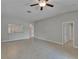Bright living room with tile flooring, ceiling fan, and view into kitchen area, creating an open space at 14047 Weddington Ter, Hudson, FL 34669