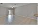 Open-concept living room with tile floors, a ceiling fan, and sliding glass doors to a patio at 14047 Weddington Ter, Hudson, FL 34669
