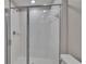 Tiled walk-in shower with glass doors and chrome fixtures at 14047 Weddington Ter, Hudson, FL 34669