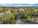 A home aerial view showcases the property nestled among mature trees in a serene neighborhood at 15405 Woodstar Landing Ct, Lithia, FL 33547