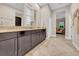 Bathroom vanity with double sinks, tile flooring, and natural light at 15405 Woodstar Landing Ct, Lithia, FL 33547