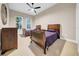 Comfortable bedroom showcasing two beds, soft carpet, a ceiling fan, and natural light at 15405 Woodstar Landing Ct, Lithia, FL 33547
