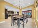 Dining area with views into the kitchen and the adjacent Gathering room with a purple accent wall at 15405 Woodstar Landing Ct, Lithia, FL 33547