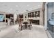 Dining area with modern wine bar adjacent to a kitchen and sunny seating area at 15405 Woodstar Landing Ct, Lithia, FL 33547