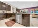 View of the kitchen's stainless steel dishwasher blending into a living area with vibrant color at 15405 Woodstar Landing Ct, Lithia, FL 33547