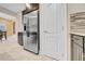 A modern kitchen featuring a stainless steel refrigerator and stylish tile flooring at 15405 Woodstar Landing Ct, Lithia, FL 33547