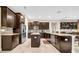 Spacious kitchen featuring dark wood cabinetry, stainless steel appliances, and a large island at 15405 Woodstar Landing Ct, Lithia, FL 33547