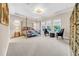 Bright main bedroom featuring a four-poster bed and sitting area with ample sunlight at 15405 Woodstar Landing Ct, Lithia, FL 33547
