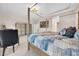 A main bedroom with a four-poster bed, dresser, and view of the bathroom at 15405 Woodstar Landing Ct, Lithia, FL 33547