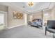 Spacious main bedroom with a four-poster bed and neutral carpeting at 15405 Woodstar Landing Ct, Lithia, FL 33547