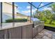 Outdoor kitchen with stainless steel grill in a screened patio, ideal for outdoor cooking at 15405 Woodstar Landing Ct, Lithia, FL 33547