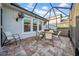 Screened patio featuring an outdoor grill and dining space for entertaining at 15405 Woodstar Landing Ct, Lithia, FL 33547