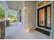 Inviting front porch featuring stone accents and a decorative front door at 15405 Woodstar Landing Ct, Lithia, FL 33547