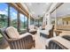 Bright sunroom with comfortable seating and a view of the lush backyard at 15405 Woodstar Landing Ct, Lithia, FL 33547