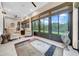 A bright sunroom featuring large windows and neutral decor at 15405 Woodstar Landing Ct, Lithia, FL 33547