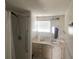Bathroom featuring shower stall, sink, vanity and a window at 1710 7Th Sw St # 82, Ruskin, FL 33570