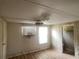 Bedroom featuring paneled walls, laminated flooring, and two windows at 1710 7Th Sw St # 82, Ruskin, FL 33570