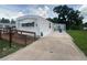 Mobile home with a ramp and a concrete driveway, providing ample parking space at 1710 7Th Sw St # 82, Ruskin, FL 33570