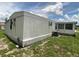 Exterior view of the side and back of the home, with some green space at 1710 7Th Sw St # 82, Ruskin, FL 33570