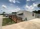 Exterior featuring a wooden ramp that leads to the front door, providing easy access to the home at 1710 7Th Sw St # 82, Ruskin, FL 33570