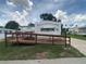 Charming white mobile home with a wooden ramp and awning in a well-maintained community at 1710 7Th Sw St # 82, Ruskin, FL 33570