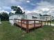 Exterior view of a well-maintained mobile home with a ramp, enhancing accessibility and curb appeal at 1710 7Th Sw St # 82, Ruskin, FL 33570