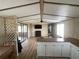 Spacious living room featuring laminated flooring, a ceiling fan and sliding glass doors at 1710 7Th Sw St # 82, Ruskin, FL 33570