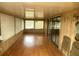 Sunroom with laminate flooring and large windows allowing ample sunlight at 1710 7Th Sw St # 82, Ruskin, FL 33570