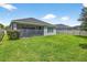 Large backyard with well-kept lawn and screened in lanai, perfect for outdoor enjoyment at 17651 Bright Wheat Dr, Lithia, FL 33547