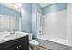 Bright, fully-functional bathroom with toilet, sink and shower-tub combo with white tile at 17651 Bright Wheat Dr, Lithia, FL 33547