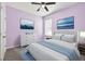 Cozy bedroom featuring calming wall art, a ceiling fan, and complementary light blue accents at 17651 Bright Wheat Dr, Lithia, FL 33547