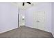 This bedroom features light purple walls, gray carpet, ceiling fan, and double door closet at 17651 Bright Wheat Dr, Lithia, FL 33547