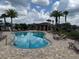 Community pool with lounge chairs and shady pavilion, perfect for relaxing and socializing at 17651 Bright Wheat Dr, Lithia, FL 33547