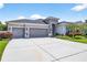 Stunning single-story home boasting a three-car garage and spacious driveway at 17651 Bright Wheat Dr, Lithia, FL 33547