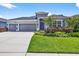 Charming single-story home featuring a well-manicured lawn and a three-car garage at 17651 Bright Wheat Dr, Lithia, FL 33547