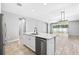 Open-concept kitchen with a center island, stainless steel dishwasher, and views of the dining area at 17651 Bright Wheat Dr, Lithia, FL 33547