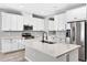 Bright kitchen featuring white cabinetry, stainless steel appliances, and a center island at 17651 Bright Wheat Dr, Lithia, FL 33547