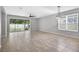 Spacious living room with tile floors, large windows, and sliding glass doors to the backyard at 17651 Bright Wheat Dr, Lithia, FL 33547