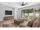Living room with sliding glass doors, fan, and comfortable seating at 17651 Bright Wheat Dr, Lithia, FL 33547
