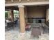 Covered outdoor kitchen featuring counter seating, sink, and tile flooring, perfect for entertaining guests and relaxing at 17651 Bright Wheat Dr, Lithia, FL 33547