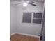 Small bedroom featuring wood floors, a ceiling fan, a window, and light-colored walls at 1922 Marvy Ave, Tampa, FL 33612