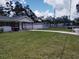 Well-kept lawn with single-story home and detached garage at 1922 Marvy Ave, Tampa, FL 33612