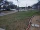 Image of a house, as seen from the front yard, facing toward the street showing a curb and grass at 1922 Marvy Ave, Tampa, FL 33612