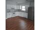 A well-lit, recently updated kitchen features white cabinetry, laminate countertops, and modern appliances at 1922 Marvy Ave, Tampa, FL 33612